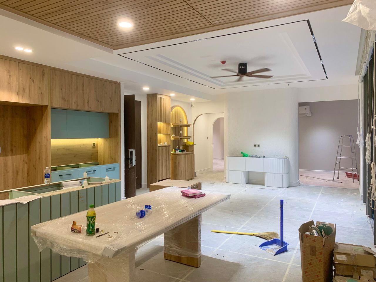 Services Spacious modern kitchen and dining area under renovation with wooden cupboards and stylish design.